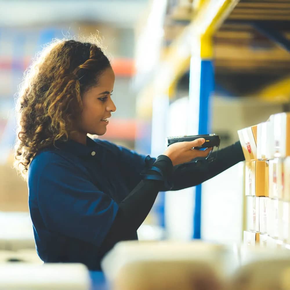 woman scanning bar code on box